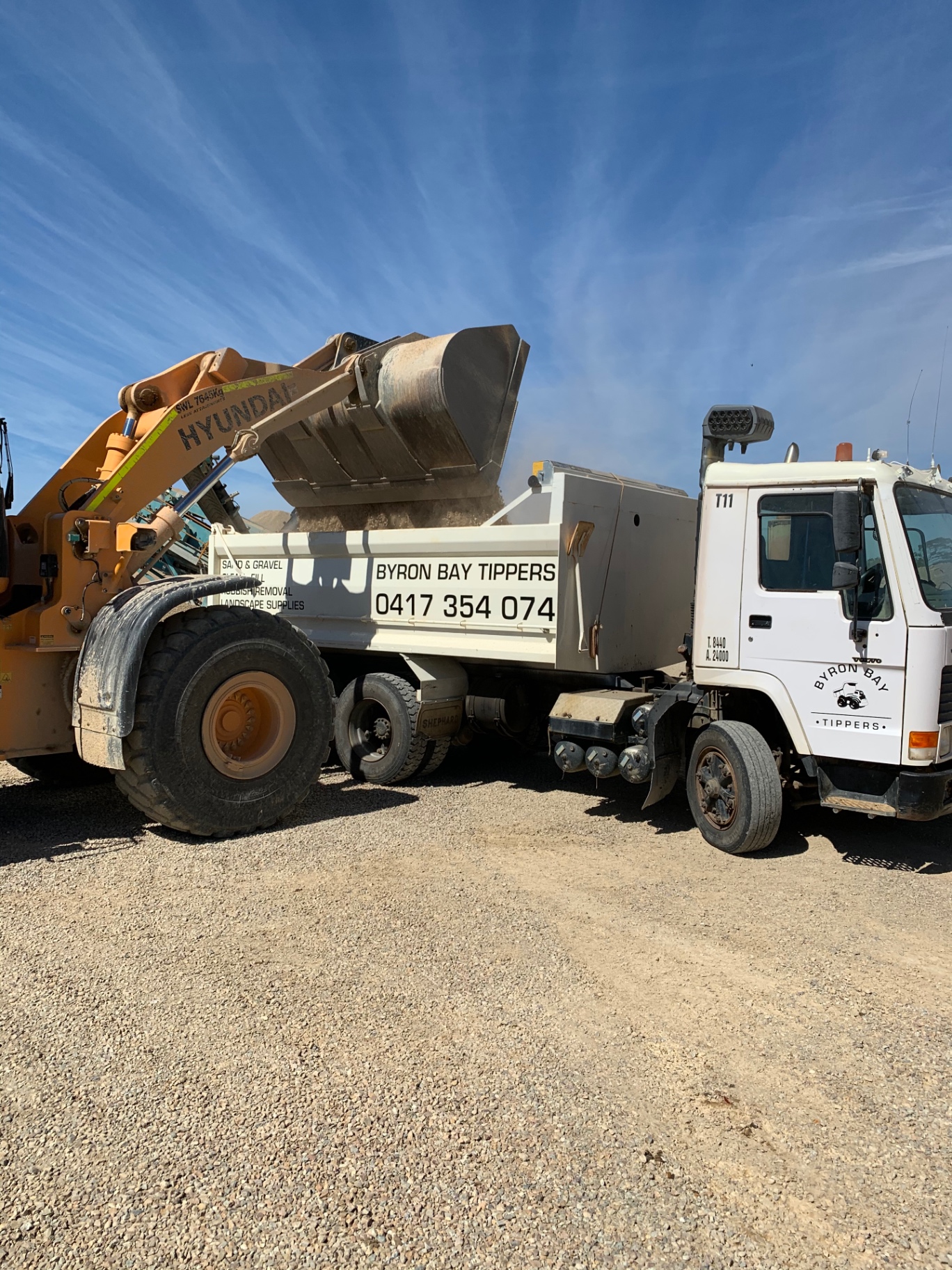 Front-end loader filling a Byron Bay Tippers tipper at the quarry